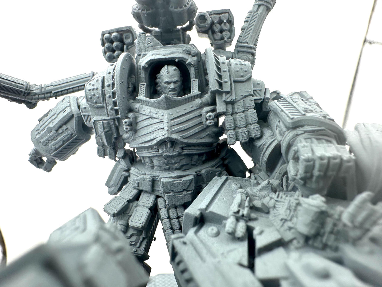 Primarch Perturabo of the Iron Warriors in full battle armour smashing Fulgrim's face
