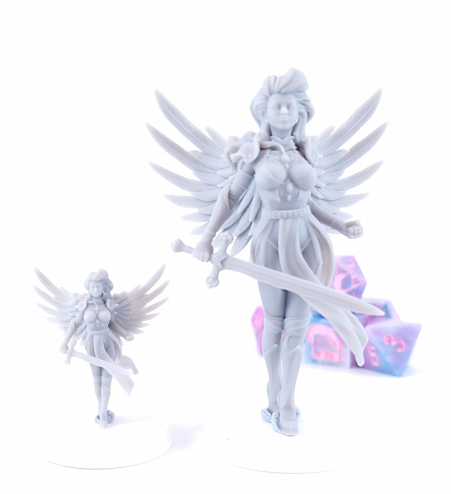 Aasimar Paladin miniature with large angelic white wings, ornate gold armor, flowing green and white tabard, red hair, and a longsword, posed on a display base.